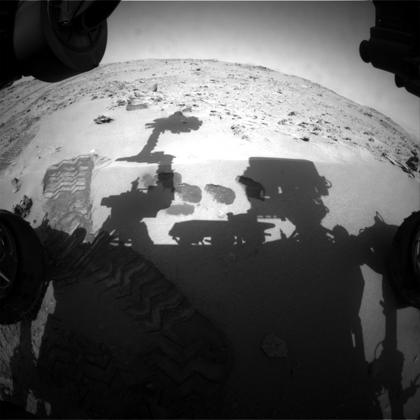A view from Curiosity's front hazcam of the sandy Mars soil the rover scooped samples of for analysis by its SAM instrument (NASA/JPL-Caltech)