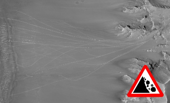 Trails of Mars rocks that have rolled down the slope of a crater rim as imaged by the HiRISE camera. Credit: NASA/JPL/Univ. of Arizona.